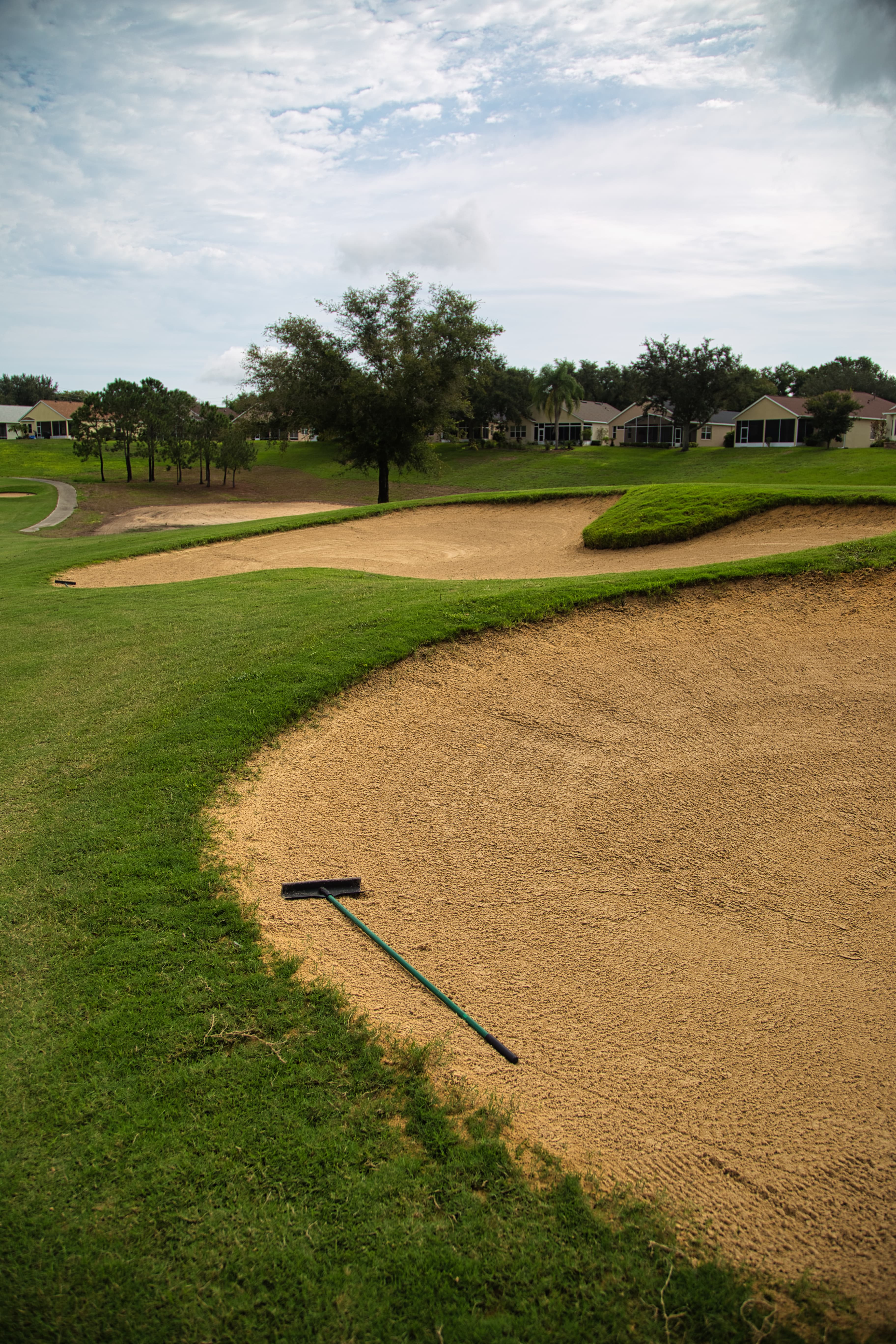 Manicured sand bunker with rake on the Clermont National course